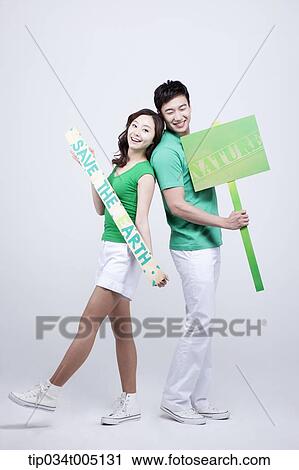 a man and a woman posing with signboards saying environmentally friendly phrases View Large Photo Image Stock Image - a man and a woman posing with signboards saying environmentally friendly phrases. Fotosearch