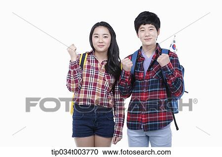Stock Image - a man and a woman wearing check shirt raising up their fists. Fotosearch