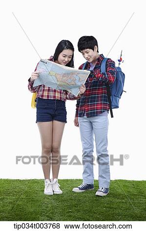 a man and a woman wearing check shirt looking at a map together View Large Photo Image Stock Photo - a man and a woman wearing check shirt looking at a map together. Fotosearch