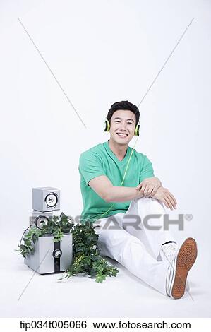 a man listening to a music with an audio set with plants View Large Photo Image Stock Photograph - a man listening to a music with an audio set with plants . Fotosearch