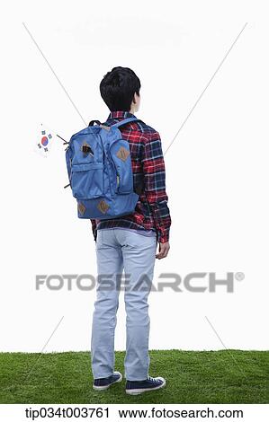 a man standing wearing a backpack View Large Photo Image Stock Image - a man standing wearing a backpack. Fotosearch