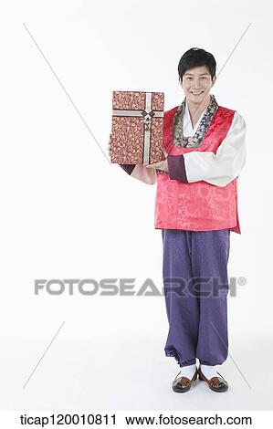 a man wearing a Hanbok holding a present View Large Photo Image Stock Image - a man wearing a Hanbok holding a present . Fotosearch