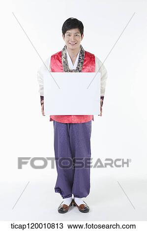 Stock Image - a man wearing a Hanbok holding a white box . Fotosearch