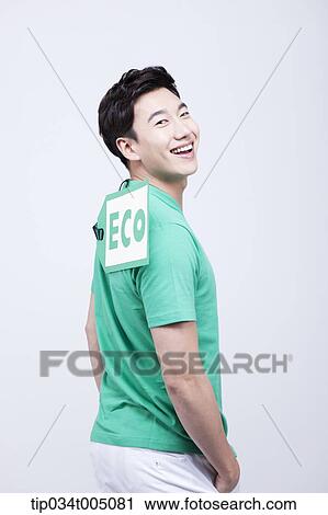 a man with a big eco tag on his green t-shirt View Large Photo Image Stock Image - a man with a big eco tag on his green t-shirt. Fotosearch