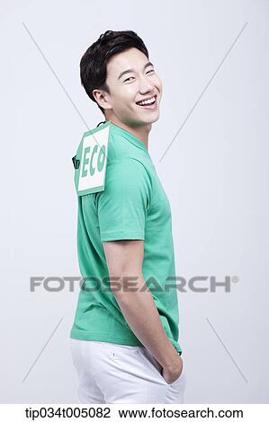 Stock Image - a man with a big eco tag on his green t-shirt. Fotosearch
