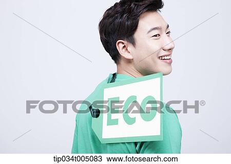 Stock Image - a man with a big eco tag on his green t-shirt. Fotosearch