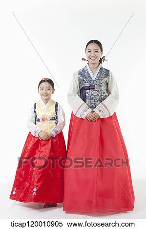 Stock Photography - a mother and a daughter standing in a line wearing Hanbok. Fotosearch
