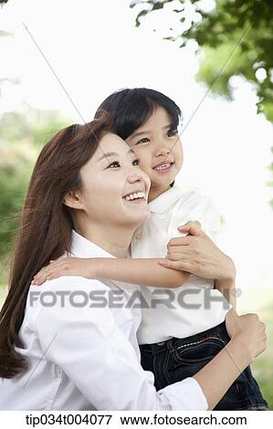 a mother and daughter hugging each other View Large Photo Image Stock Photo - a mother and daughter hugging each other. Fotosearch