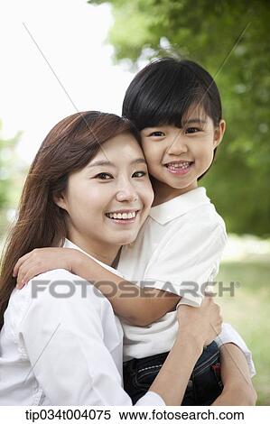 Stock Photography - a mother and daughter hugging each other. Fotosearch