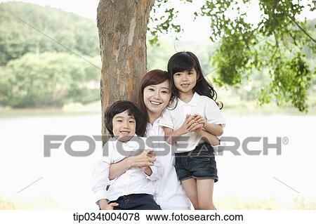 a mother between a daughter and a son View Large Photo Image Stock Photo - a mother between a daughter and a son . Fotosearch