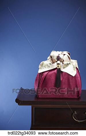 a package in a red Korean traditional wrap on a traditional table View Large Photo Image Stock Image - a package in a red Korean traditional wrap on a traditional table. Fotosearch