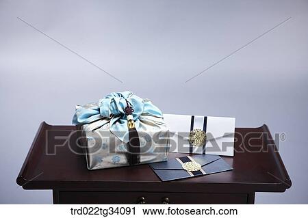Stock Image - a package in Korean traditional wrap and envelopes on traditional table. Fotosearch