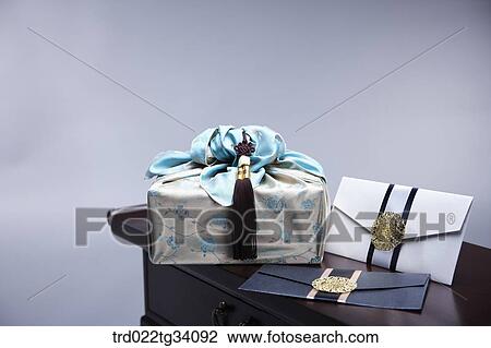 Stock Image - a package in Korean traditional wrap and envelopes on traditional table. Fotosearch