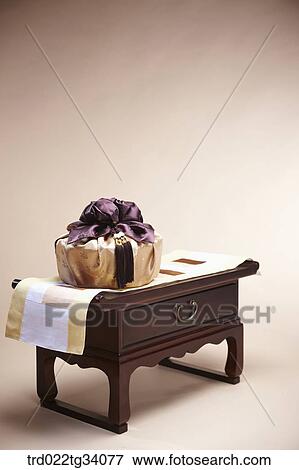 Stock Photo - a package in Korean traditional wrap placed on a traditional table . Fotosearch