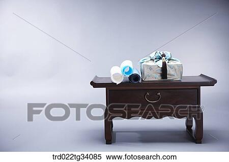a package in Korean traditional wrap and Korean traditional paper rolls on a table View Large Photo Image Stock Photography - a package in Korean traditional wrap and Korean traditional paper rolls on a table. Fotosearch