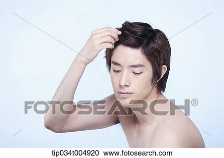 a side shot of a topless man touching his hair View Large Photo Image Stock Image - a side shot of a topless man touching his hair. Fotosearch