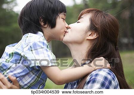 Stock Photo - a son and a mother kissing . Fotosearch