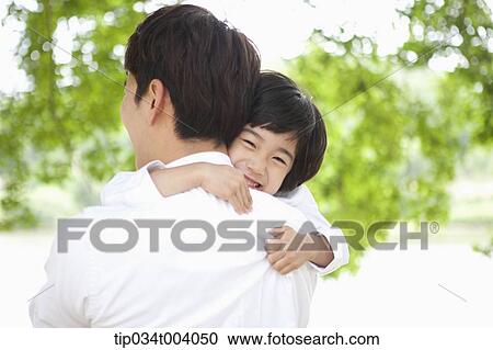 Stock Image - a son hugging a father . Fotosearch