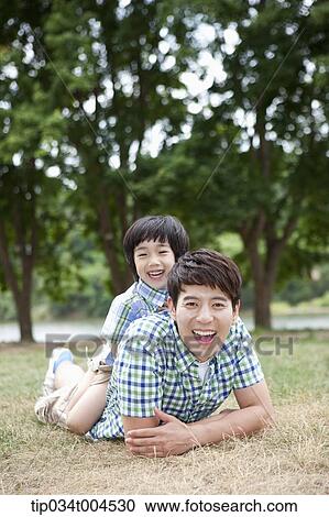 Stock Image - a son on dad's back . Fotosearch