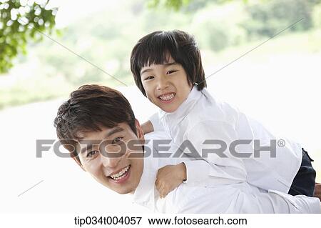 Stock Photo - a son on father's back . Fotosearch