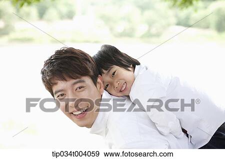 Stock Photo - a son on father's back . Fotosearch
