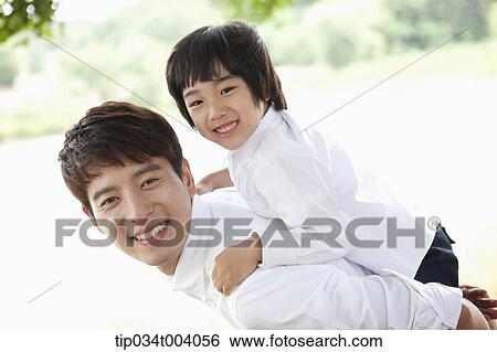 Stock Photograph - a son on father's back . Fotosearch