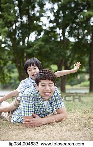a son posing on dad's back View Large Photo Image Stock Image - a son posing on dad's back . Fotosearch