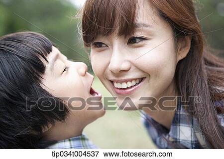 Stock Photo - a son whispering to mother. Fotosearch