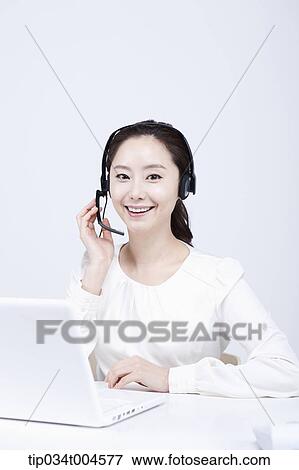 a telemarketer working with a white laptop View Large Photo Image Stock Photo - a telemarketer working with a white laptop. Fotosearch