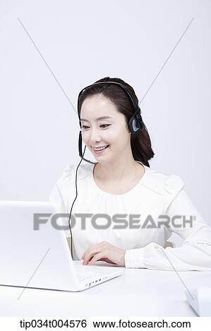 a telemarketer working with a white laptop View Large Photo Image Stock Photograph - a telemarketer working with a white laptop. Fotosearch