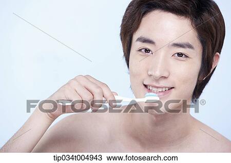 a topless man brushing his teeth View Large Photo Image Stock Image - a topless man brushing his teeth. Fotosearch