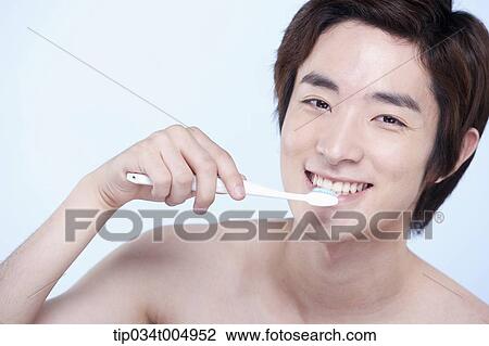 a topless man brushing his teeth View Large Photo Image Stock Image - a topless man brushing his teeth. Fotosearch