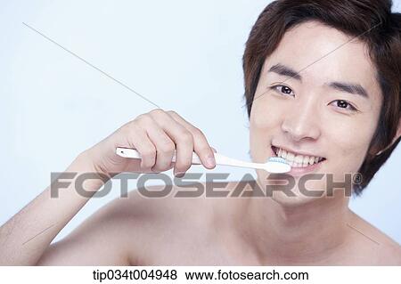 Stock Photo - a topless man brushing his teeth. Fotosearch