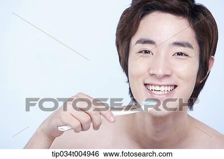 a topless man brushing his teeth View Large Photo Image Stock Photograph - a topless man brushing his teeth. Fotosearch