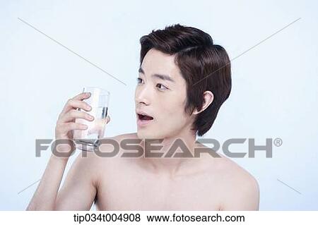 Stock Photo - a topless man holding a glass of water. Fotosearch