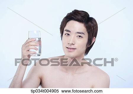 Stock Photography - a topless man holding a glass of water. Fotosearch