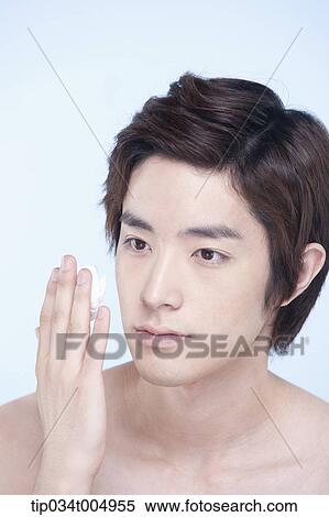 Stock Photography - a topless man looking at shaving cream on his fingers . Fotosearch