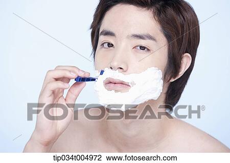 Stock Image - a topless man shaving. Fotosearch
