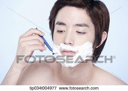 Stock Photo - a topless man shaving. Fotosearch