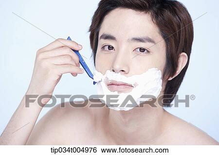 Stock Photograph - a topless man shaving. Fotosearch