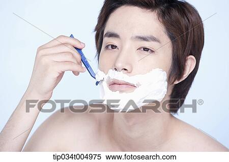 Stock Photography - a topless man shaving. Fotosearch