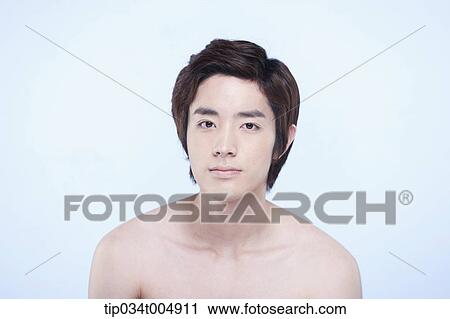 Stock Image - a topless man touching his chin. Fotosearch