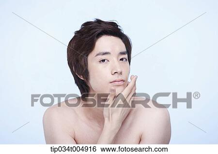 Stock Photograph - a topless man touching his chin. Fotosearch