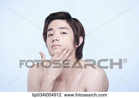 a topless man touching his hair View Large Photo Image Stock Image - a topless man touching his hair. Fotosearch