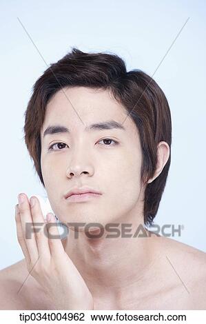 Stock Image - a topless man with shaving cream on his fingers . Fotosearch