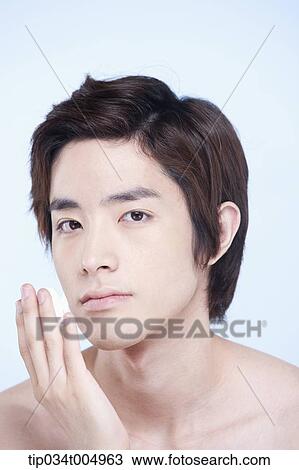 Stock Image - a topless man with shaving cream on his fingers . Fotosearch
