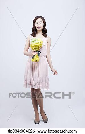 Stock Photography - A woman holding a flower bouquet . Fotosearch