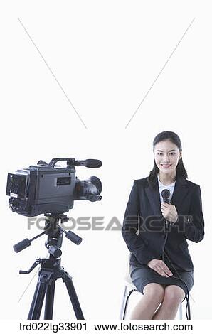 a woman in black suit explaining something with microphone View Large Photo Image Stock Image - a woman in black suit explaining something with microphone . Fotosearch