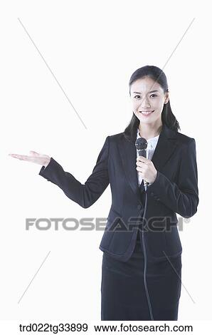 Stock Photo - a woman in black suit making an announcement with microphones . Fotosearch