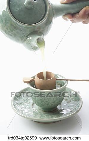 a woman pouring a tea View Large Photo Image Stock Photo - a woman pouring a tea . Fotosearch